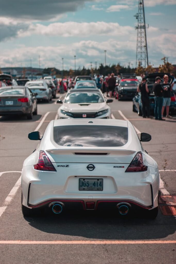 A lineup of luxury sports cars parked in a city setting during the day.